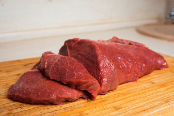 Red meat beef on a wooden cutting board