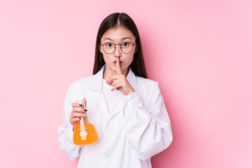 Young chinese scientific woman isolated keeping a secret or asking for silence.