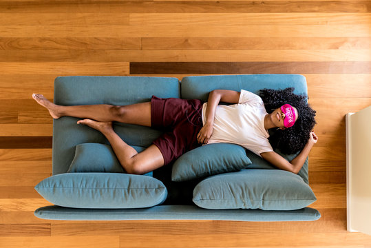 Young black lady using eye mask for sleep