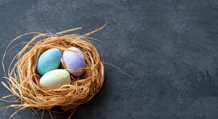 Colored Easter eggs of chalk in the nest