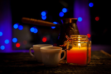 romantic still life with two cups of coffee and a candle