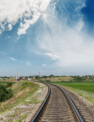 Fototapeta premium rail road to horizon in bridge and blue sky with clouds