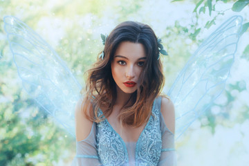 Fantasy closeup portrait attractive woman in image young fairy. carnival Costume blue dress...