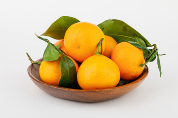 a plate with some tangerines isolated on white background