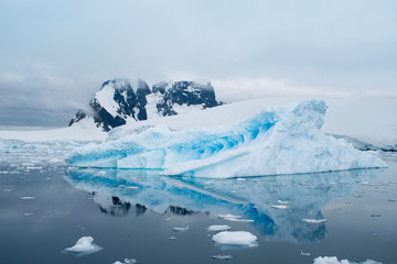 Fototapeta na wymiar Beautiful iceberg in the ocean with a view under water. Global warming concept. Melting glacier