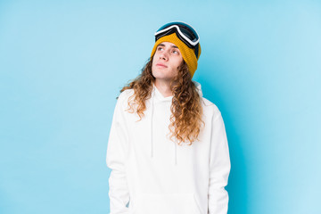 Young caucasian man wearing a ski clothes isolated  dreaming of achieving goals and purposes