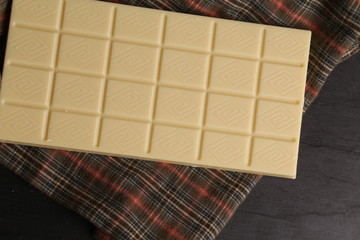 white chocolate tablet in color background