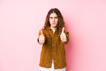 Young long hair man posing isolated with thumbs ups, cheers about something, support and respect concept.