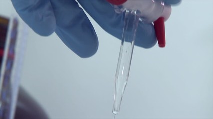 scientist lab opening stopcock and let liquid drain to erlenmeyer flask