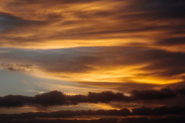 Fototapeta na wymiar cloudy sunset colourful orange red sky