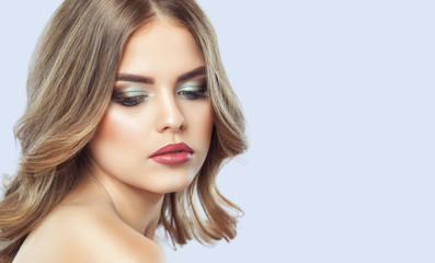 Portrait of a beautiful woman with long eyelashes, beautiful make-up, thick eyebrows and with clean...