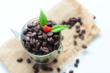 Coffee beans decorated with red heart and green leaves