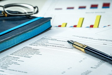 Financial income statement with calculator and pencil
