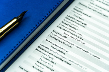 Financial income statement with calculator and pencil