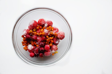 frozen berries strawberries sea buckthorn cranberries in a glass plate