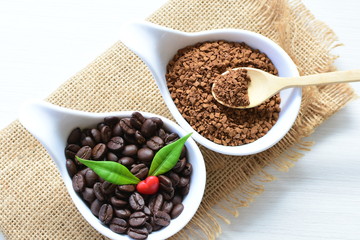 Coffee beans, accompanied by processed coffee powder