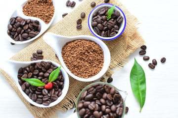 Coffee beans, accompanied by processed coffee powder