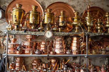 Fototapeta na wymiar Bronze and copper handcrafted cookware in street shop. Shaki, Azerbaijan.
