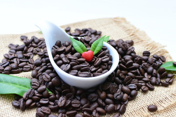 Coffee beans decorated with red heart and green leaves