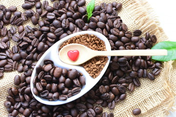 Coffee beans, accompanied by processed coffee powder