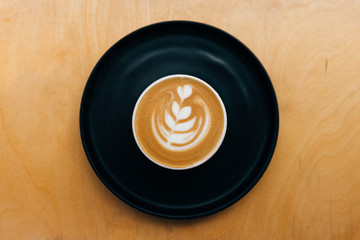 Flat White on black plate