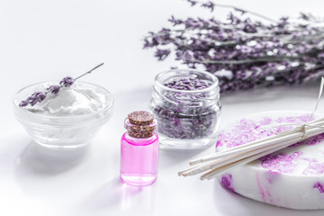 lavender herbs in body care cosmetics with oil on white table background