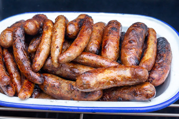 Pile of a variety of freshly cooked barbecue sausages