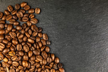 Coffee beans on slate plate. Growing coffee. Fresh coffee beans. Traditional hot drink. Fair trade.