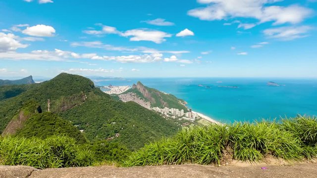 View of Rio de Janeiro from the Pedra Bonita [Beautiful Stone] with Corcovado and Two Brothers mountain and South neighbourhoods against a blue sky with clouds. Motion time lapse cityscape/ landscape.