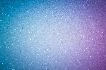 Blue-purple abstract background with sparkling glitter, dark soft vignette at the edges of a photo