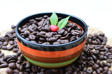 Coffee beans decorated with red heart and green leaves