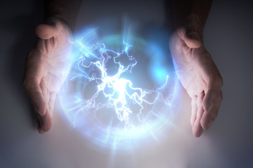 Plasma ball with lightning in hands of magician or illusionist.