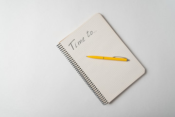 Time To written on notebook over white background. Planning concept. Top view