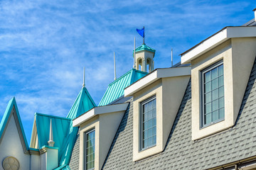 A perfect neighborhood. Houses in suburb at Summer in the north America. Top of a luxury house with nice window over dramatic pink clouds in the sky.