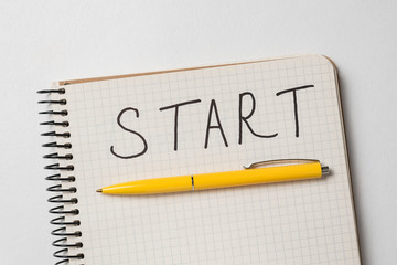 Notepad with Start inscription. Notepad and pen on white background. Handwritten