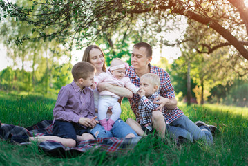 Fototapeta premium Family on picnic. Large family outdoor recreation. Mom, dad and three children.