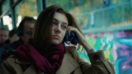 Portrait young attractive woman look on window on the tram on a cold autumn day at the start of the flu season disease fever flu grippe health illness infection influenza migraine sickness slow motion