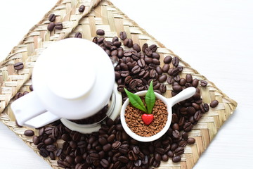 Coffee beans decorated with red heart and green leaves