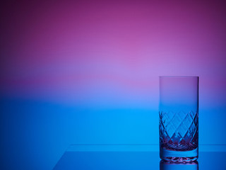 Glass close-up neon colored light gradient background