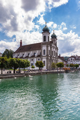 Beautiful view of the Lucerne Jesuit Church (Jesuitenkirche) on Reuss river side in old town of...
