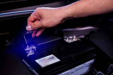 Check and maintenance the battery in car with yourself. Service and maintenance car or vehicle. Hand checking battery of car.