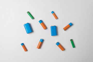 AA, AAA and PP3 batteries on white background.