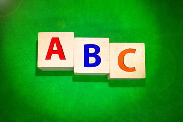 ABC blocks in front of a green chalkboard with copy space