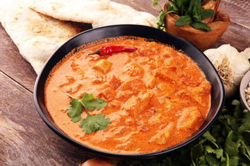 Chicken tikka masala spicy curry meat food in pot with rice and naan bread. indian food