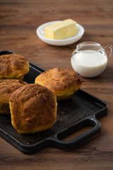 HANDCRAFTED CORN BREAD, ECUADORIAN KITCHEN RECIPE, SERVED ON WOODEN TABLE, WITH MILK AND BUTTER