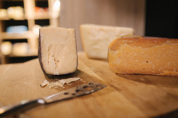 Different types of aged cheese on wooden board
