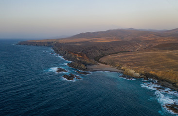 Obraz premium Ajuy, Fuerteventura, Canary Islands Spain - october 2019: the Cuevas de Ajuy, a network of limestone cliffs and caves on the Atlantic ocean coast, once used by pirates. Aerial view