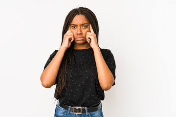 Young african american woman isolated on white background focused on a task, keeping forefingers pointing head.