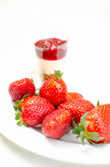 cherry cheesecake in plastic cup with strawberry  foreground focus