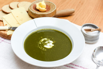 Bowl of spinach soup with a swirl of cream healthy food starter or main meal